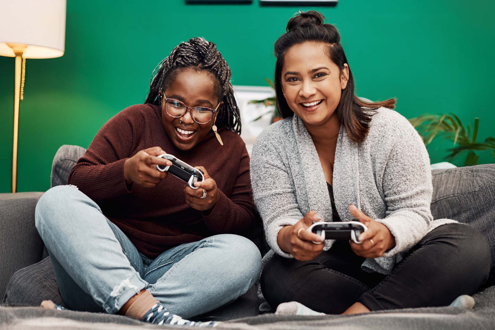 Young woman enjoying gaming console with fibre internet connection